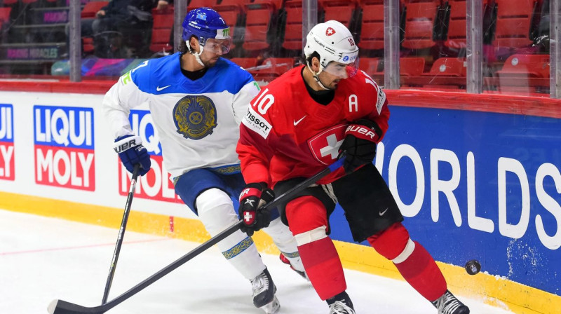 Šveices hokeja izlases veterāns Andress Ambīls cīņā par ripu. Foto: Andrea Cardin/HHOF-IIHF Images